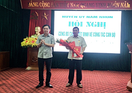 Đồng chí Lò Văn Cương – Bí thư Huyện ủy trao quyết định nghỉ chế độ hưu trí và tặng hoa đồng chí Quàng Văn Trực.